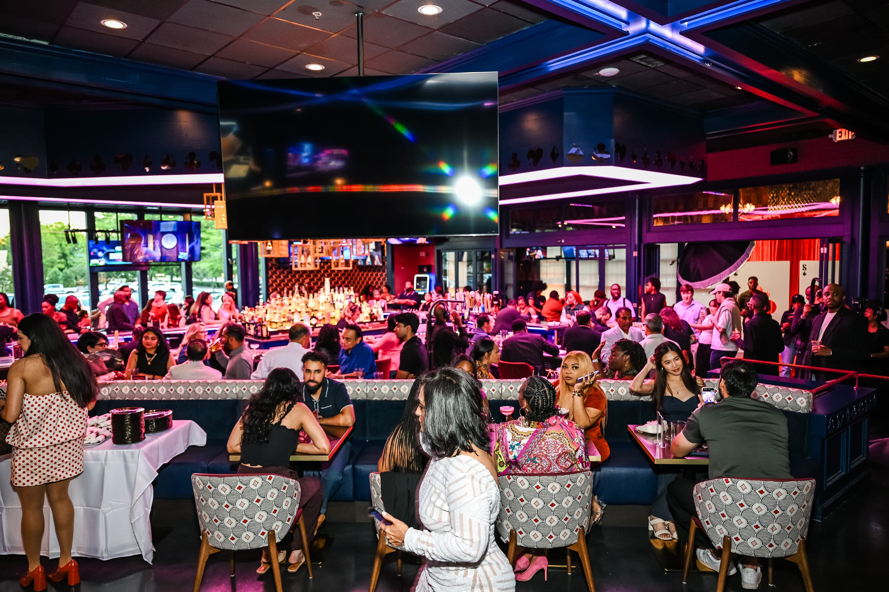 Guests gathered around the large screens at Showdown Social